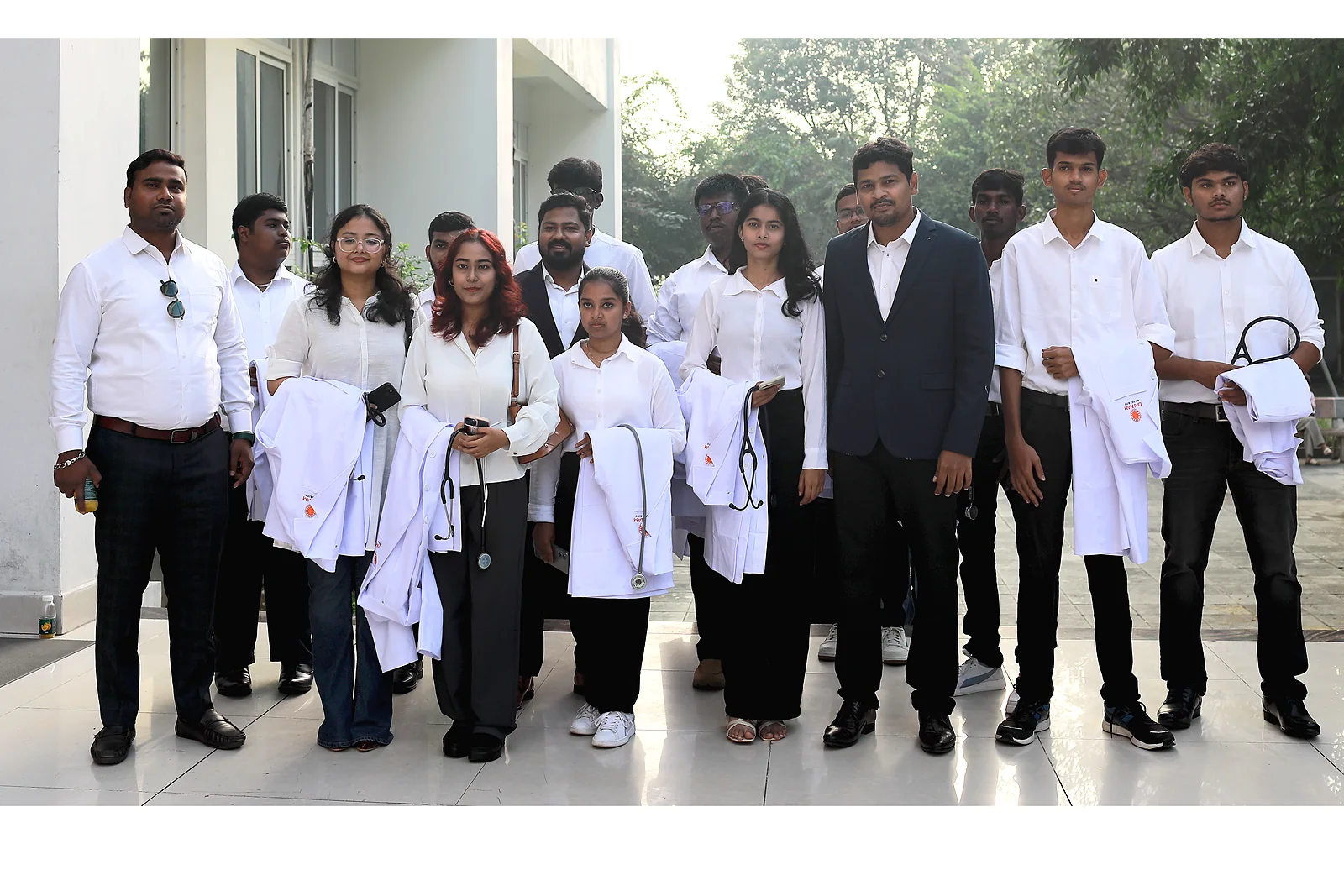 Medical students in white coats and stethoscopes with clinical mentors