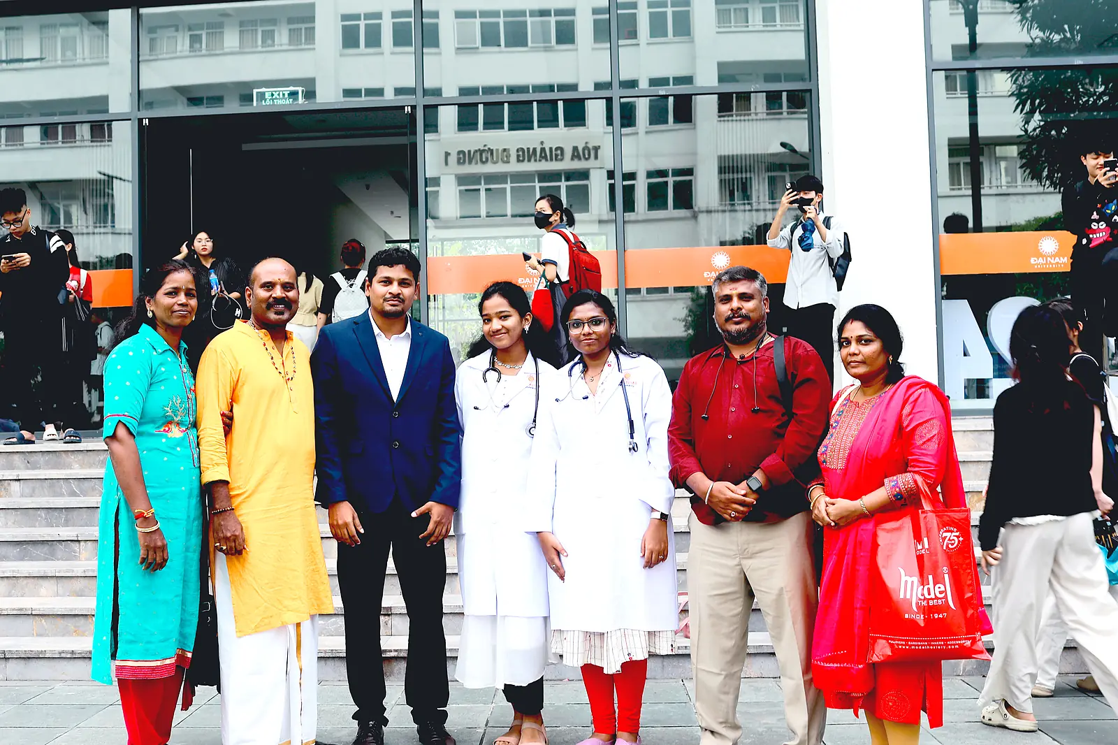 Indian parents visiting Dai Nam University with students outside the lecture hall